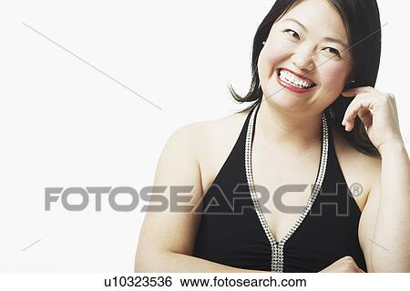 Stock Photograph - Portrait of a mid adult woman smiling. Fotosearch
