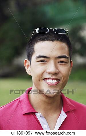 Portrait of a young man smiling View Large Photo Image Stock Photo - Portrait of a young man smiling. Fotosearch