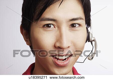 Portrait of a young man wearing a headset View Large Photo Image Stock Image - Portrait of a young man wearing a headset. Fotosearch