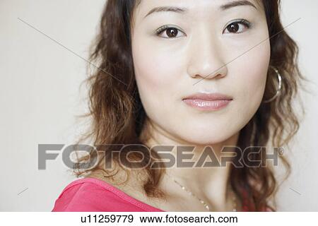 Stock Photo - Portrait of a young woman grinning. Fotosearch