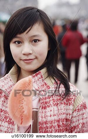 Portrait of a young woman holding a watermelon View Large Photo Image Stock Photo - Portrait of a young woman holding a watermelon. Fotosearch