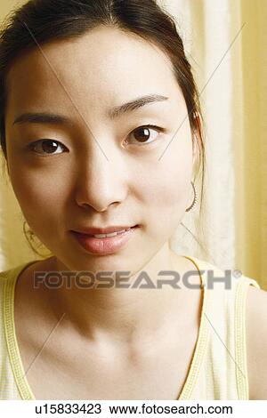 Portrait of a young woman smiling View Large Photo Image Stock Image - Portrait of a young woman smiling. Fotosearch