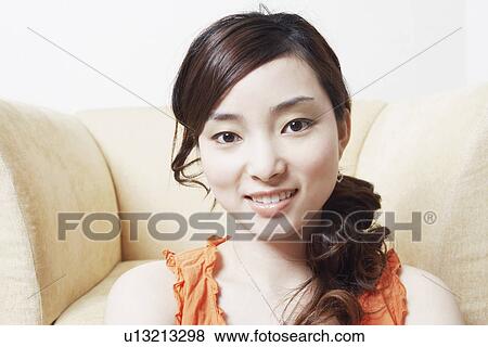 Stock Photo - Portrait of a young woman smiling. Fotosearch