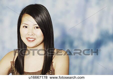 Portrait of a young woman smiling View Large Photo Image Stock Photo - Portrait of a young woman smiling. Fotosearch