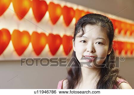 Stock Photograph - Portrait of a young woman smiling. Fotosearch