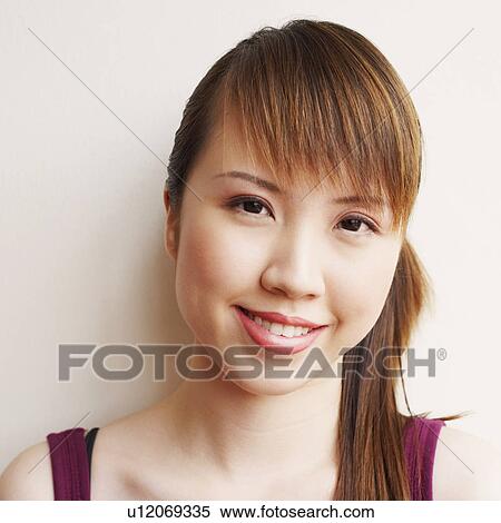 Stock Photography - Portrait of a young woman smiling. Fotosearch