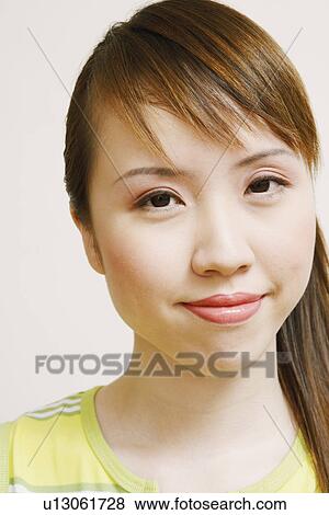 Stock Photo - Portrait of a young woman smirking. Fotosearch