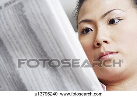 Close-up of a businesswoman reading a financial newspaper View Large Photo Image Stock Image - Close-up of a businesswoman reading a financial newspaper. Fotosearch