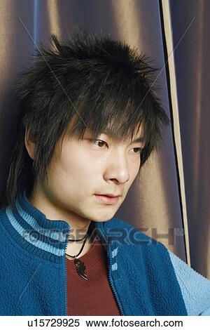 Stock Photography - Close-up of a young man thinking. Fotosearch