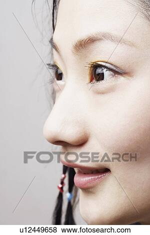 Close-up of a young woman smiling View Large Photo Image Stock Photo - Close-up of a young woman smiling. Fotosearch