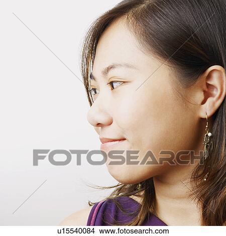 Close-up of a young woman smirking View Large Photo Image Picture - Close-up of a young woman smirking. Fotosearch