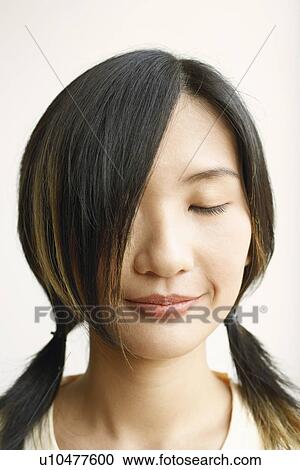Close-up of a young woman with her eyes closed View Large Photo Image Stock Image - Close-up of a young woman with her eyes closed. Fotosearch