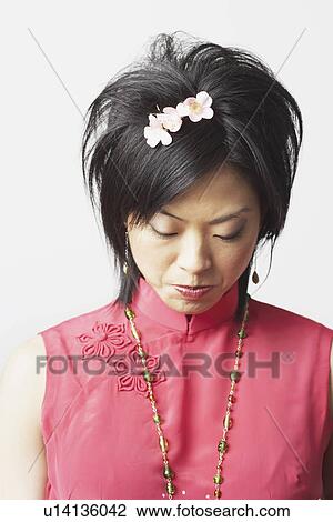 High angle view of a young woman looking serious View Large Photo Image Stock Image - High angle view of a young woman looking serious. Fotosearch