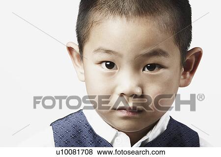 Stock Photo - Portrait of a boy looking serious. Fotosearch