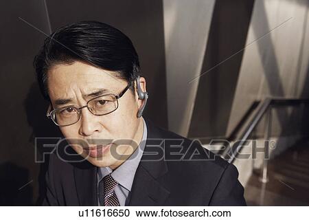 Stock Image - Portrait of a businessman looking serious. Fotosearch