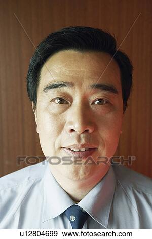 Stock Photo - Portrait of a businessman looking serious. Fotosearch