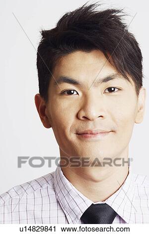 Stock Image - Portrait of a businessman smirking. Fotosearch