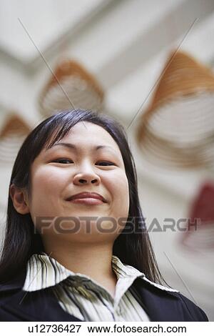 Portrait of a businesswoman smirking View Large Photo Image Stock Photo - Portrait of a businesswoman smirking. Fotosearch
