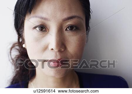 Picture - Portrait of a mature woman looking serious. Fotosearch