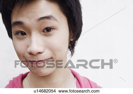 Portrait of a teenage boy making a face View Large Photo Image Picture - Portrait of a teenage boy making a face. Fotosearch