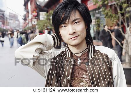 Portrait of a young man smirking View Large Photo Image Picture - Portrait of a young man smirking. Fotosearch