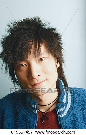 Stock Photo - Portrait of a young man smirking. Fotosearch