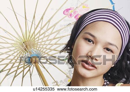 Portrait of a young woman looking serious View Large Photo Image Stock Photography - Portrait of a young woman looking serious. Fotosearch