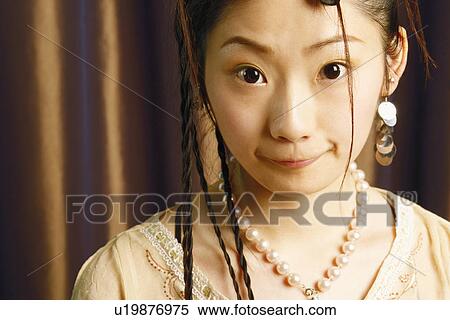 Portrait of a young woman making a face View Large Photo Image Stock Photography - Portrait of a young woman making a face. Fotosearch