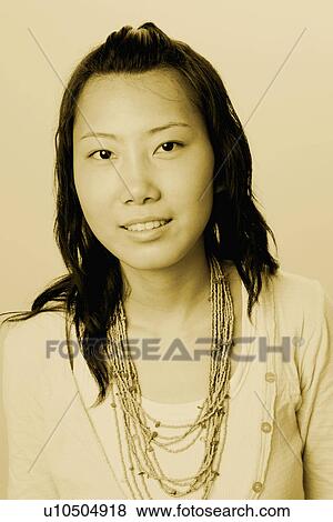 Portrait of a young woman smiling View Large Photo Image Stock Photo - Portrait of a young woman smiling. Fotosearch