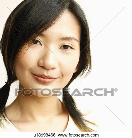 Stock Photograph - Portrait of a young woman smiling. Fotosearch