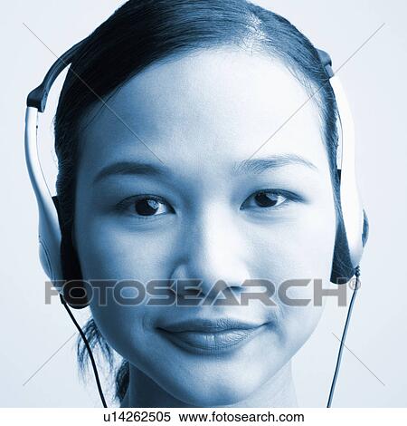 Portrait of a young woman wearing headphones View Large Photo Image Stock Photography - Portrait of a young woman wearing headphones. Fotosearch