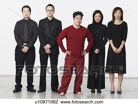 Stock Image - Portrait of three young men and two young women looking serious. Fotosearch
