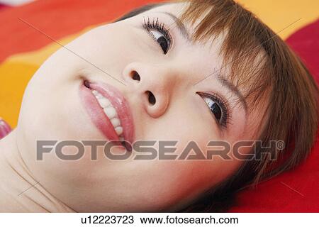 Stock Image - Close-up of a young woman smiling. Fotosearch