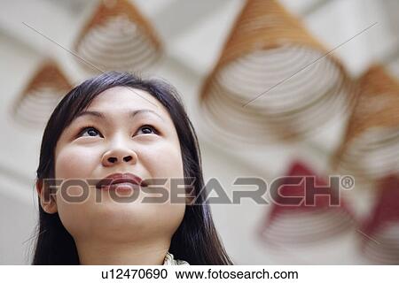 Close-up of a young woman thinking View Large Photo Image Stock Image - Close-up of a young woman thinking. Fotosearch