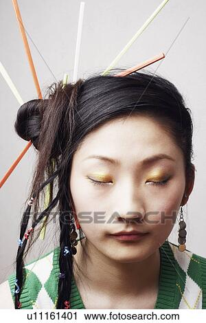 Stock Image - Close-up of a young woman with her eyes closed. Fotosearch