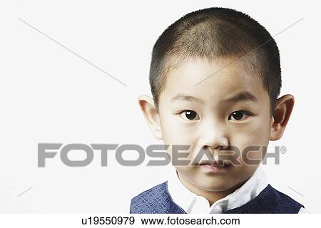 Stock Photo - Portrait of a boy looking serious. Fotosearch