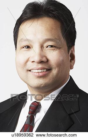 Stock Image - Portrait of a businessman smiling. Fotosearch