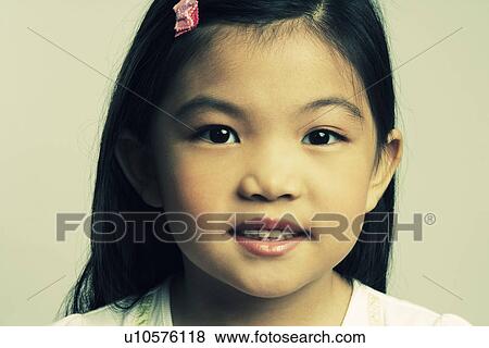 Stock Photo - Portrait of a girl smiling. Fotosearch