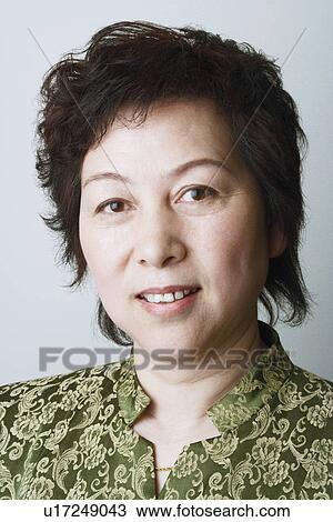 Portrait of a mature woman smiling View Large Photo Image Stock Image - Portrait of a mature woman smiling. Fotosearch