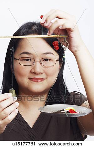 Portrait of a mid adult woman holding petals on a weighing scale View Large Photo Image Stock Image - Portrait of a mid adult woman holding petals on a weighing scale. Fotosearch
