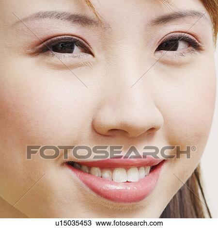 Stock Image - Portrait of a young woman smiling. Fotosearch