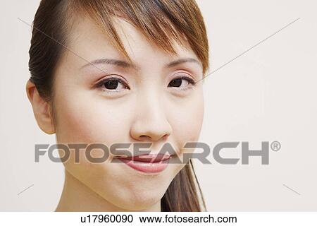 Stock Image - Portrait of a young woman smiling. Fotosearch