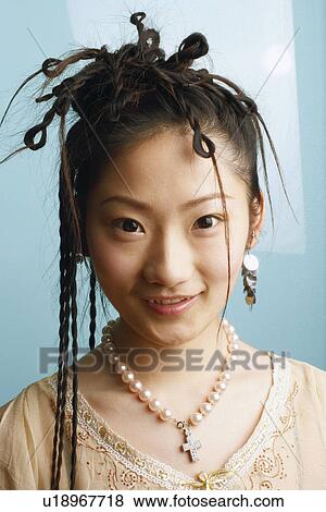 Portrait of a young woman smiling View Large Photo Image Stock Photo - Portrait of a young woman smiling. Fotosearch
