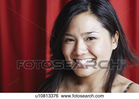 Portrait of a young woman smiling View Large Photo Image Stock Photograph - Portrait of a young woman smiling. Fotosearch