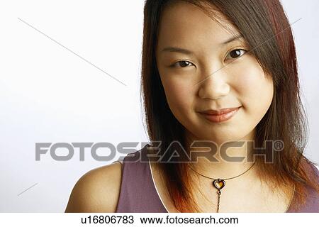 Portrait of a young woman smirking View Large Photo Image Stock Image - Portrait of a young woman smirking. Fotosearch