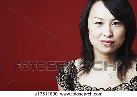 Portrait of a young woman smirking View Large Photo Image Stock Image - Portrait of a young woman smirking. Fotosearch