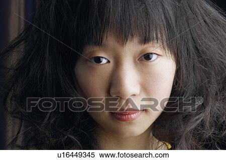 Stock Photography - Portrait of a young woman thinking. Fotosearch