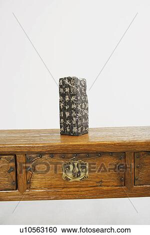 Stock Image - Close-up of a stone carved with Chinese script. Fotosearch