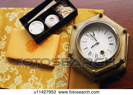 Close-up of candles and incenses in a box near a clock View Large Photo Image Stock Image - Close-up of candles and incenses in a box near a clock. Fotosearch