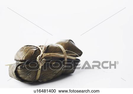 Close-up of rice wrapped in banana leaves View Large Photo Image Stock Image - Close-up of rice wrapped in banana leaves. Fotosearch